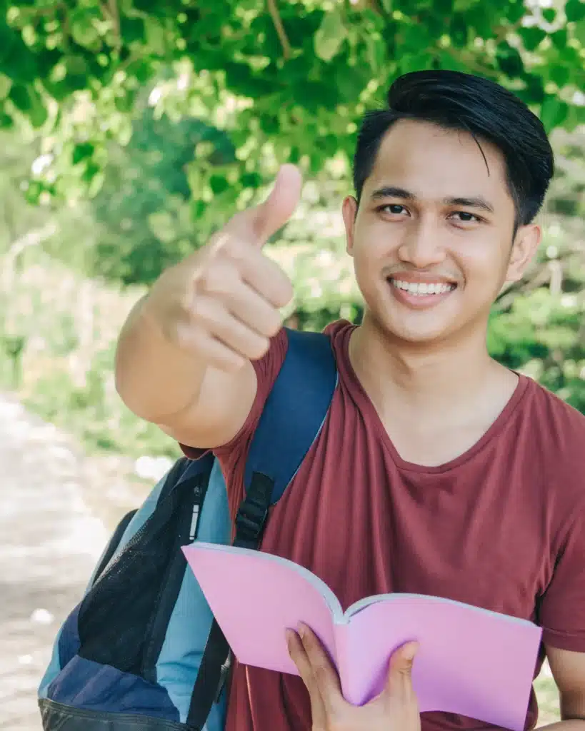 student giving thumbs up on camera – id card printing with data entry
